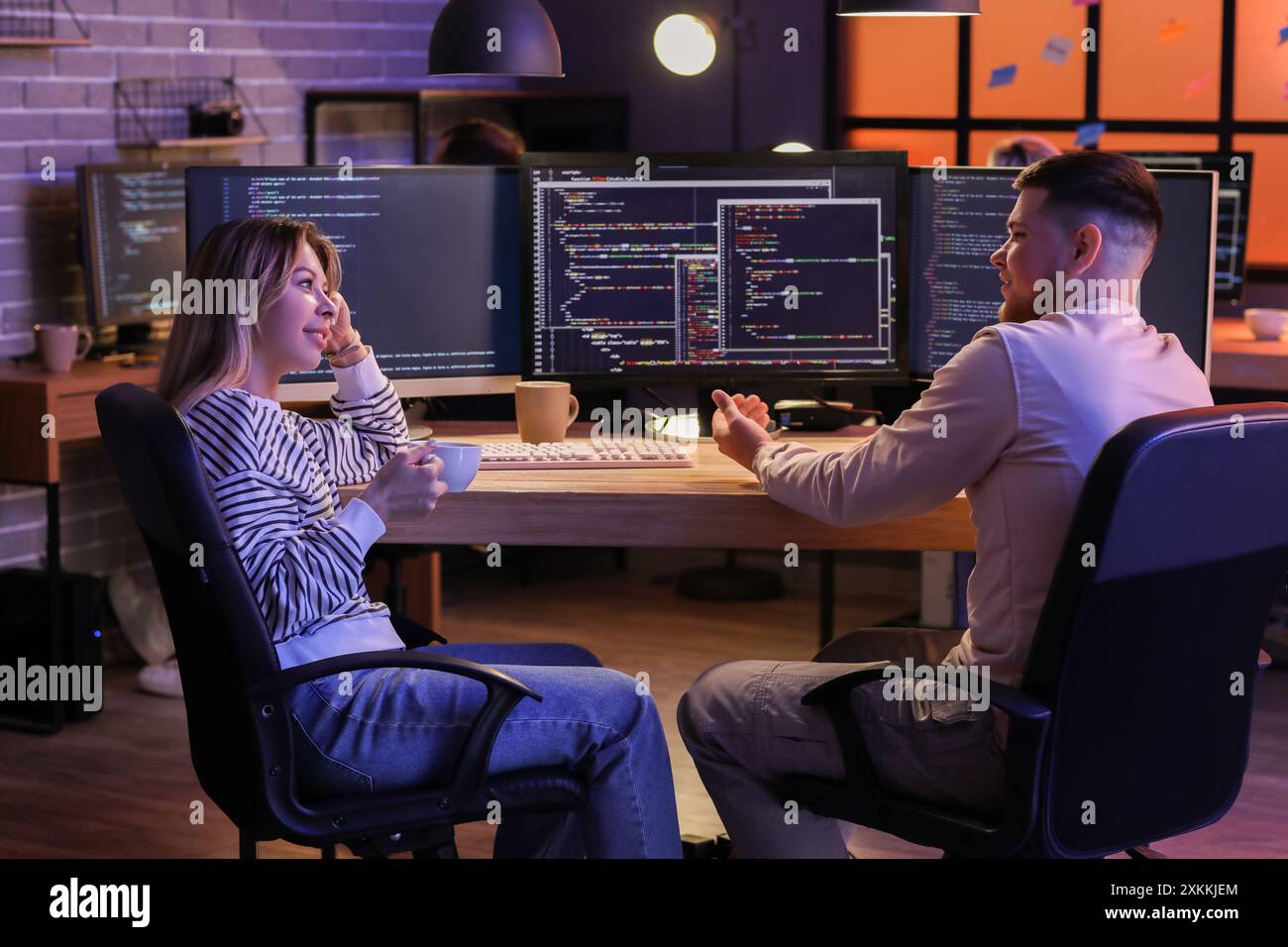 Young programmers working in office at night Stock Photo