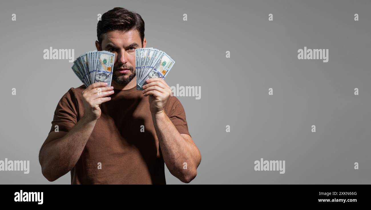 Man with money cash. Dollar Banknotes. Portrait of man holding bunch of ...