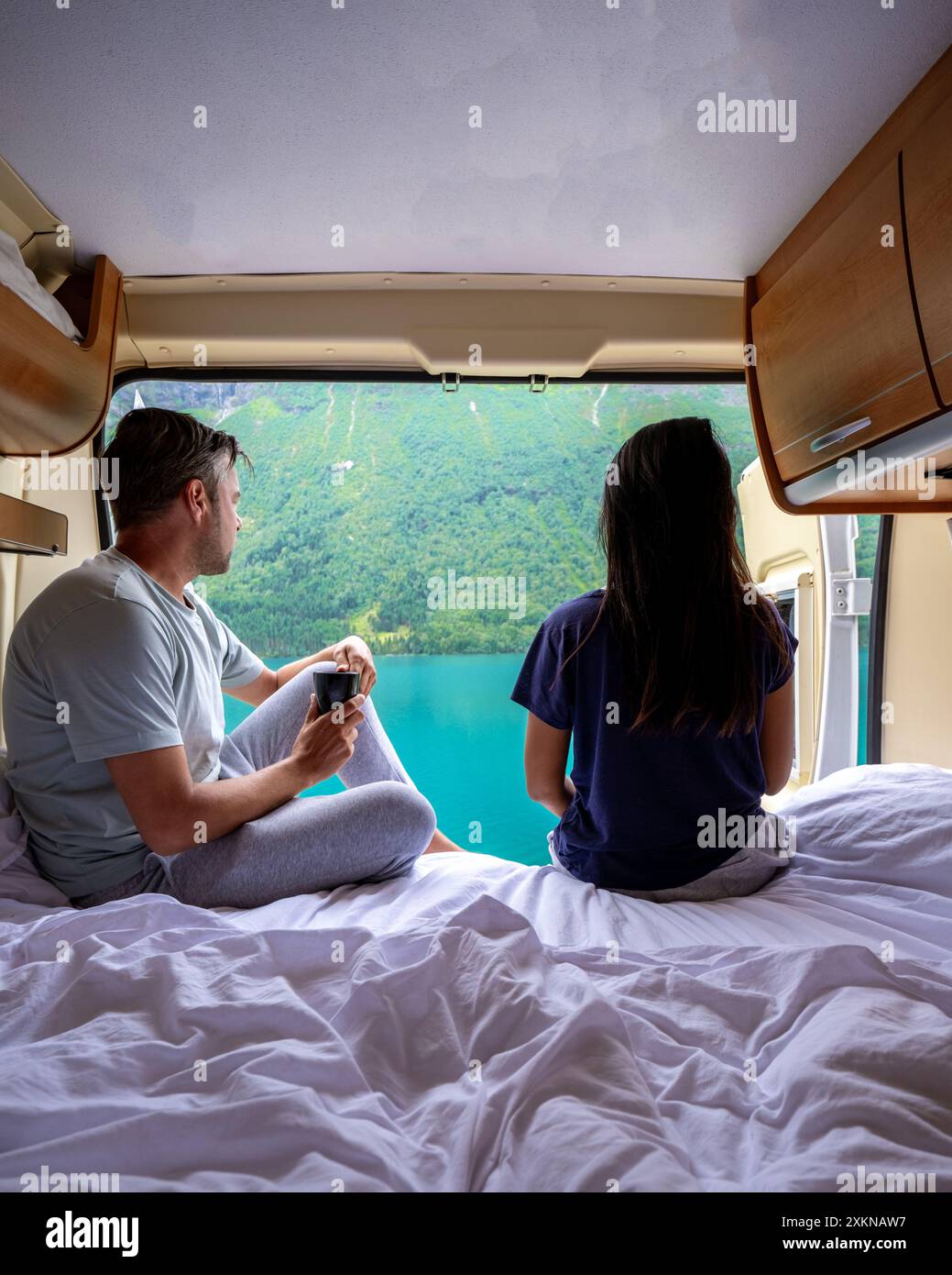 A Couple Enjoys A Relaxing Morning In Their Camper Van Taking In The a-couple-enjoys-a-relaxing-morning-in-their-camper-van-taking-in-the