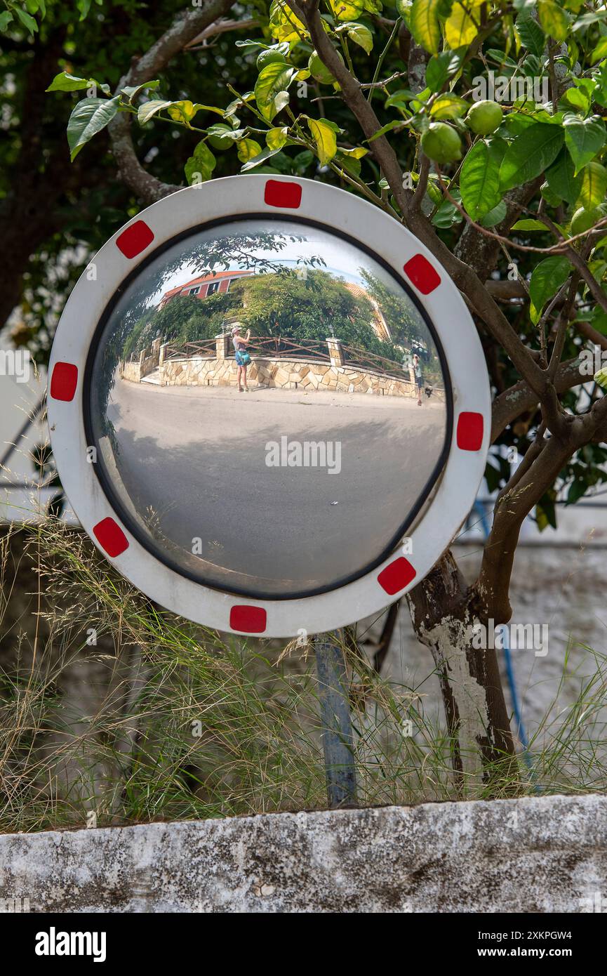 convex roadside mirror, blind exit, blind entrance, safety mirror, round view mirror. Stock Photo