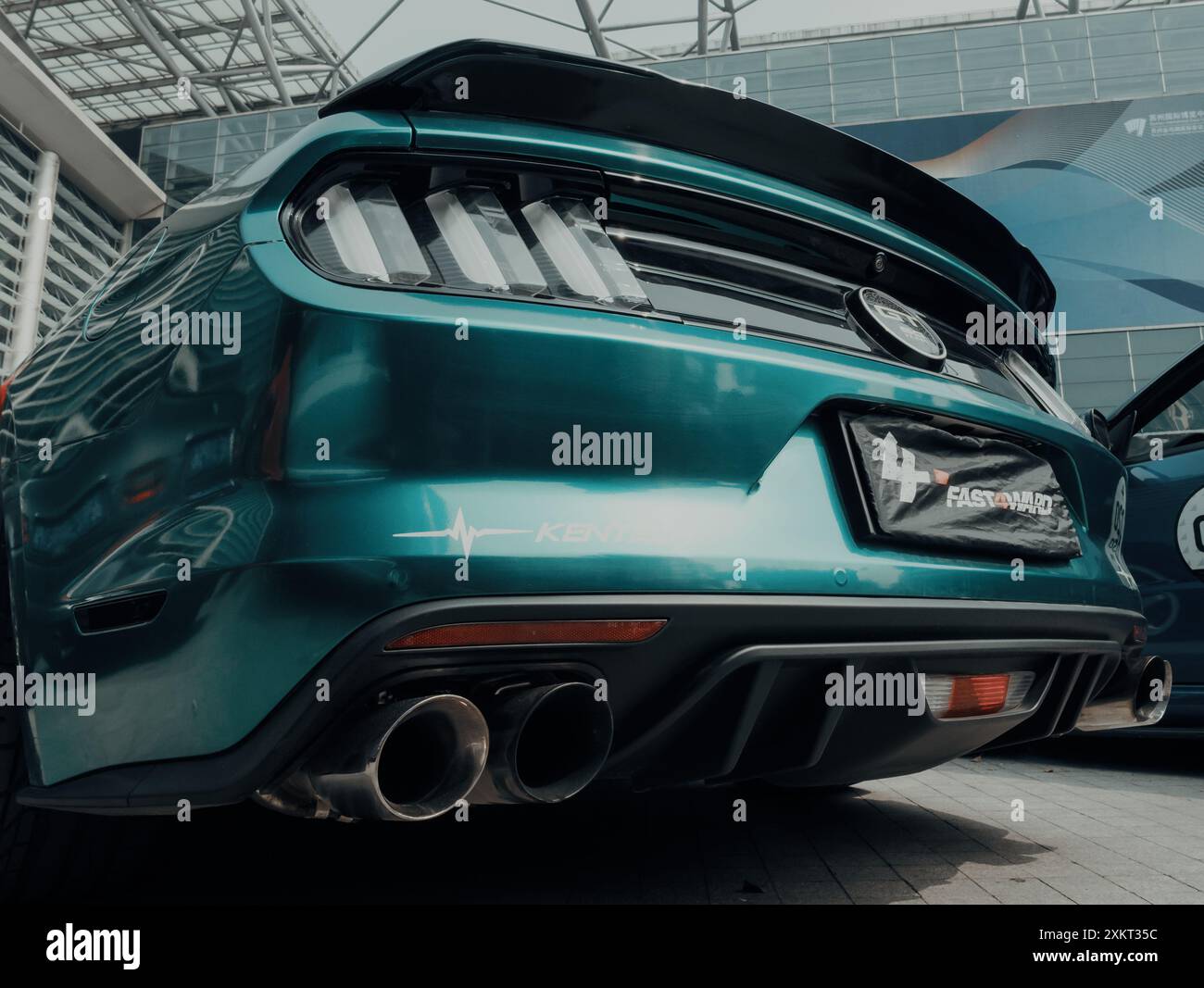 Suzhou, China - March 30, 2019: Teal mustang at a car show with custom exhaust and spoiler Stock Photo