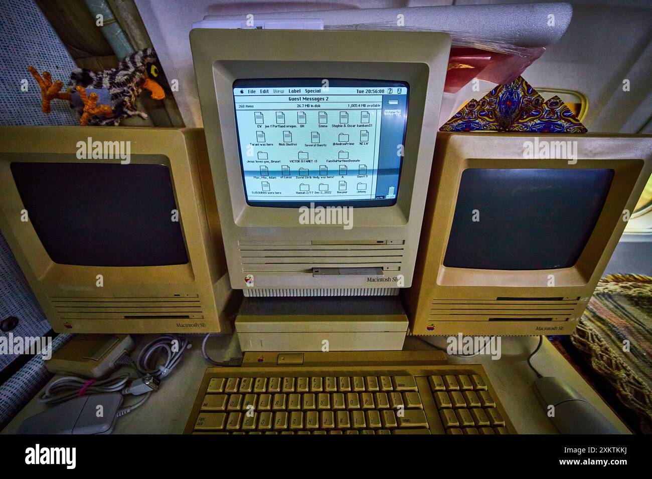 Vintage Macintosh SE Computers in Cluttered Workspace at Eye Level Stock Photo