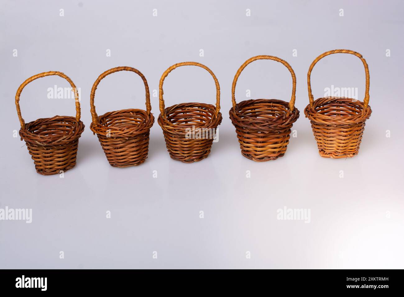 Little size Empty wicker baskets on white background Stock Photo - Alamy