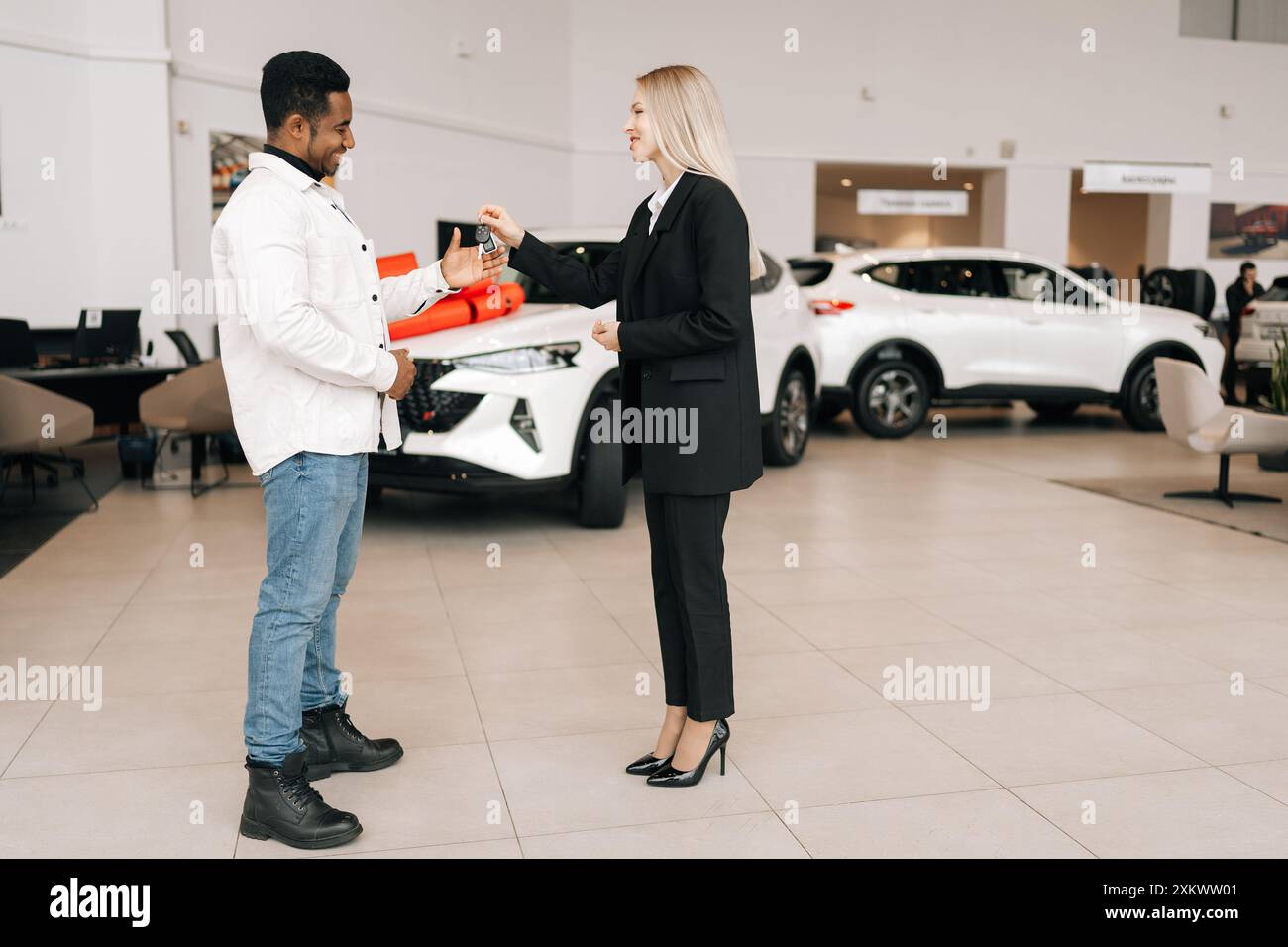 Car dealer giving handshake young hi-res stock photography and images ...