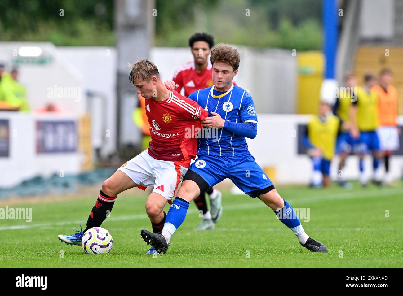 Daniel Armer of Manchester United and Iwan Murray of Chester battle for the ball during the Pre-season friendly match Chester vs Manchester United at Deva Stadium, Chester, United Kingdom, 24th July 2024  (Photo by Cody Froggatt/News Images) Stock Photo