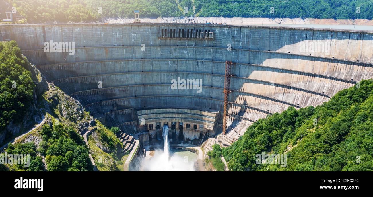 Aerial panorama of large dam of HPP or hydro power plant surrounded by ...