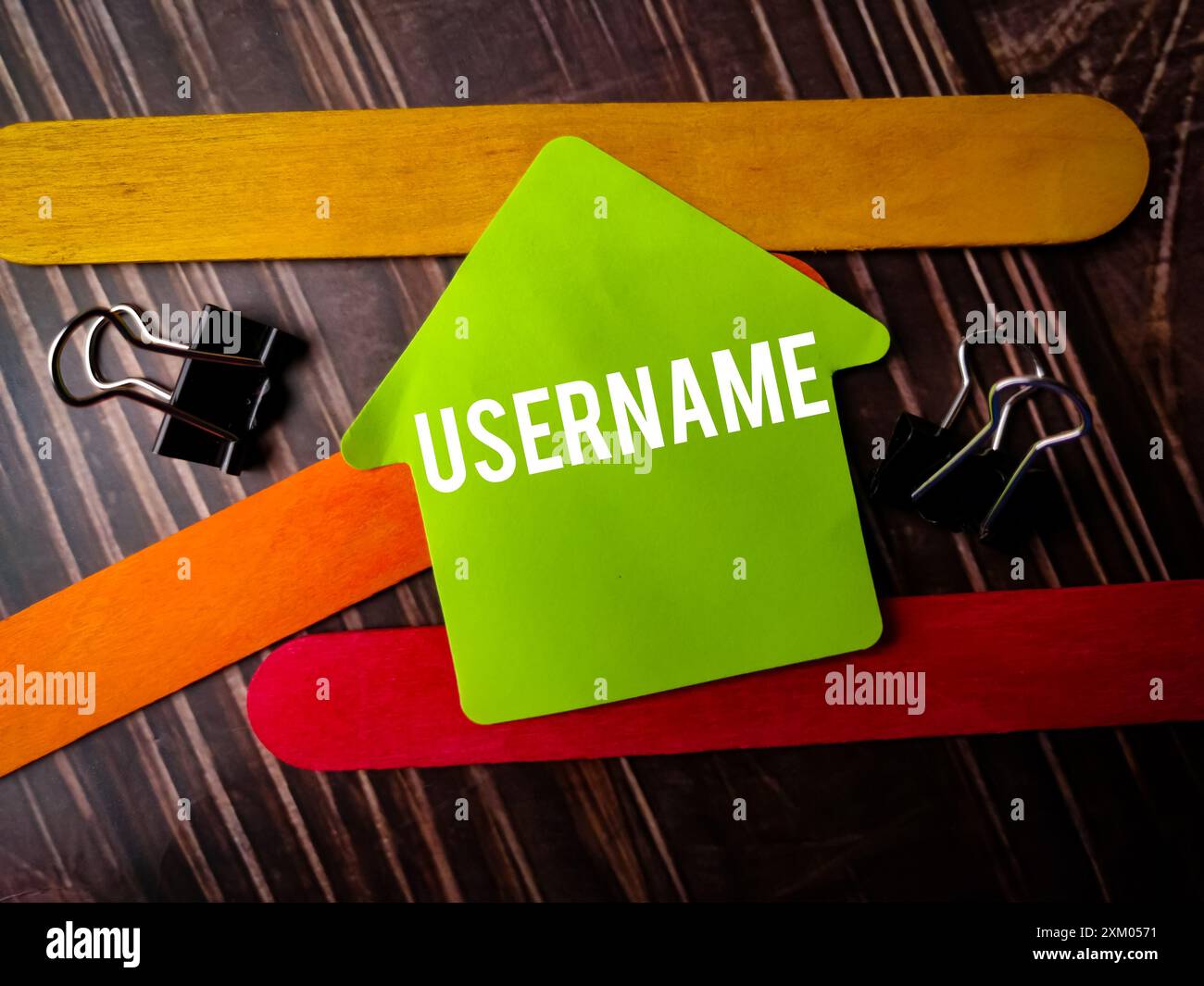 Colored sticky note written with text USERNAME on wooden table. Stock Photo