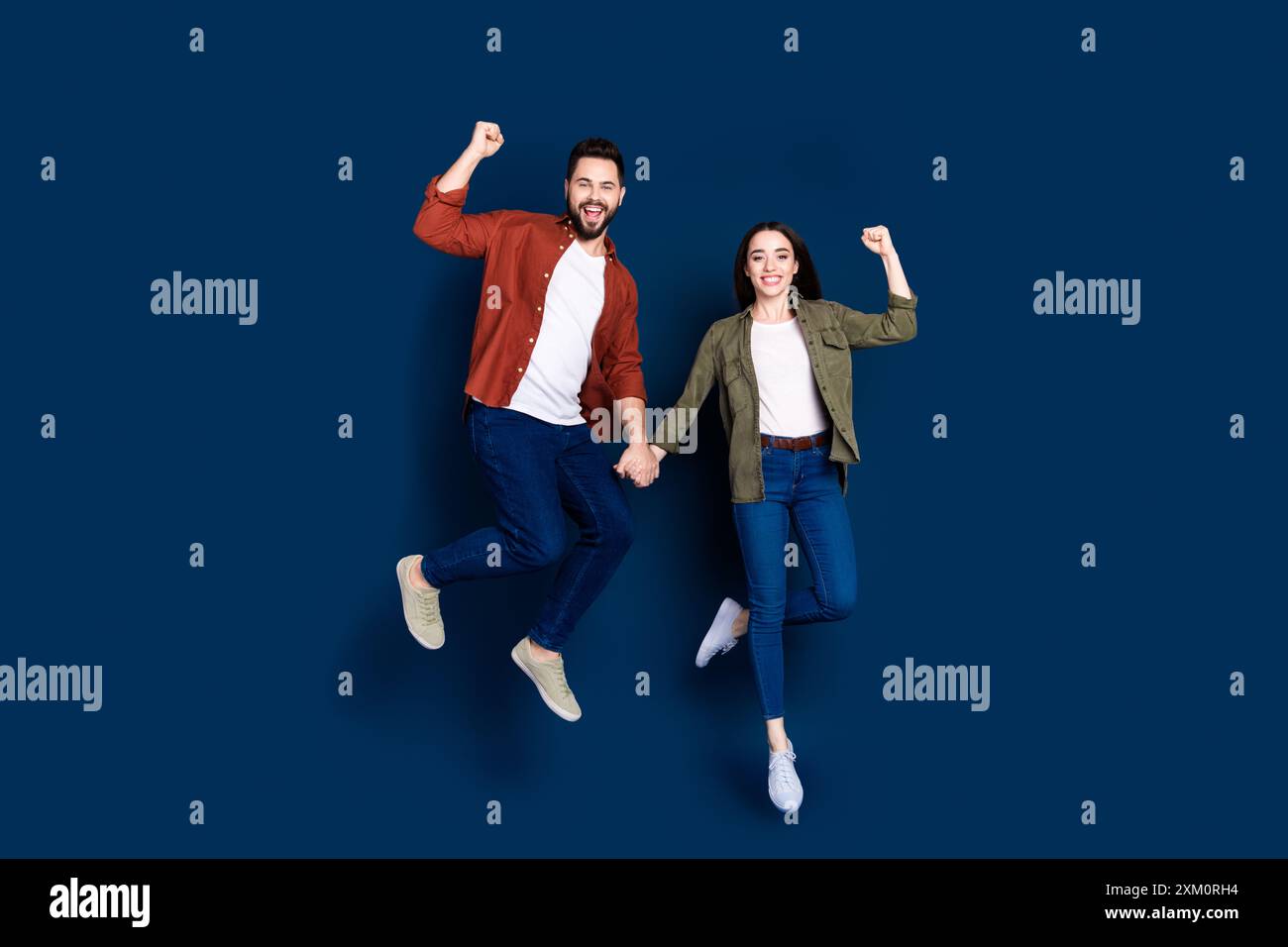 Photo of cheerful positive lovely couple wife husband wear stylish outfit  fist hand discount isolated on dark blue color background Stock Photo -  Alamy