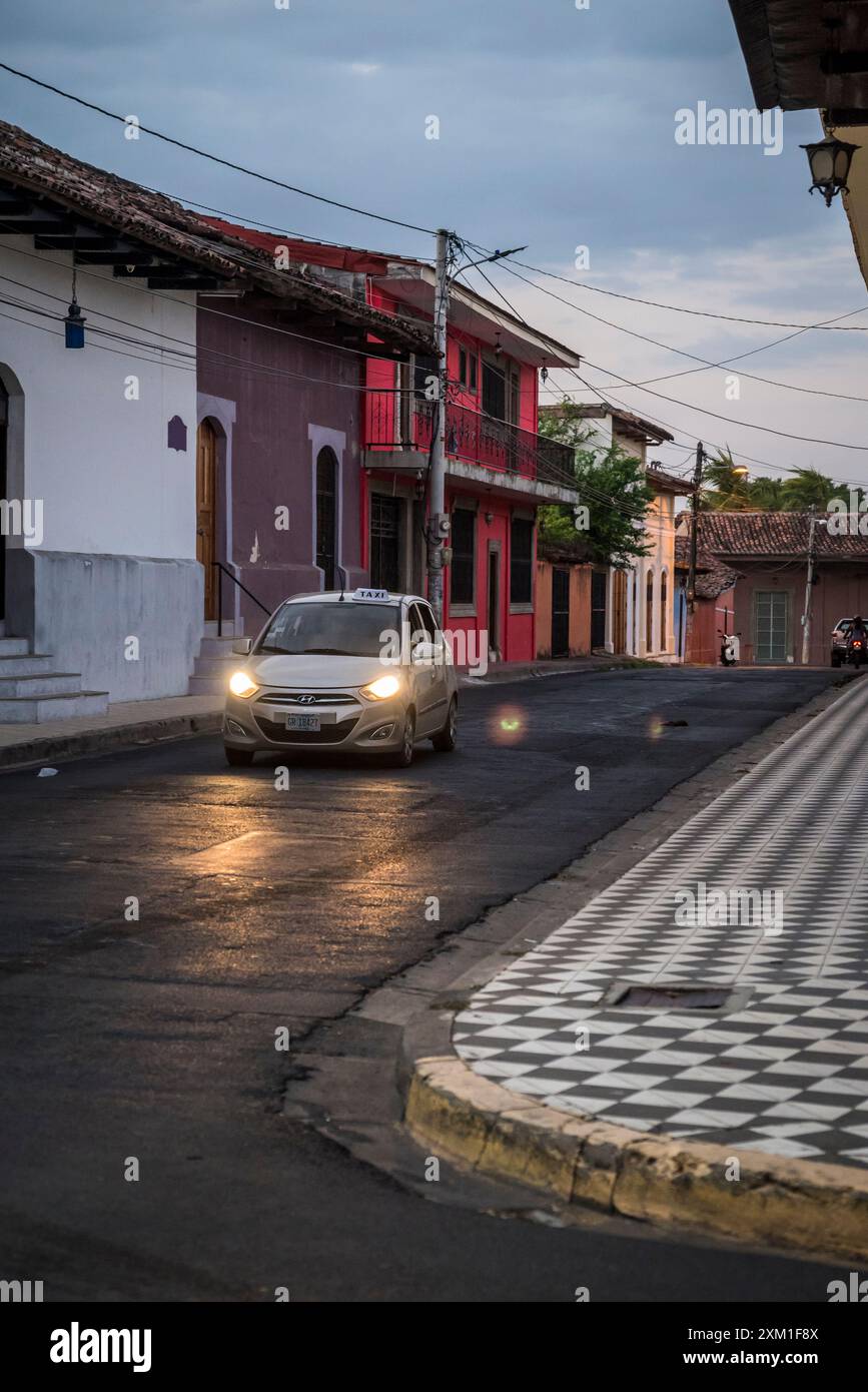 Colonial style street in the city centre at dusk, Granada, Nicaragua Stock Photo