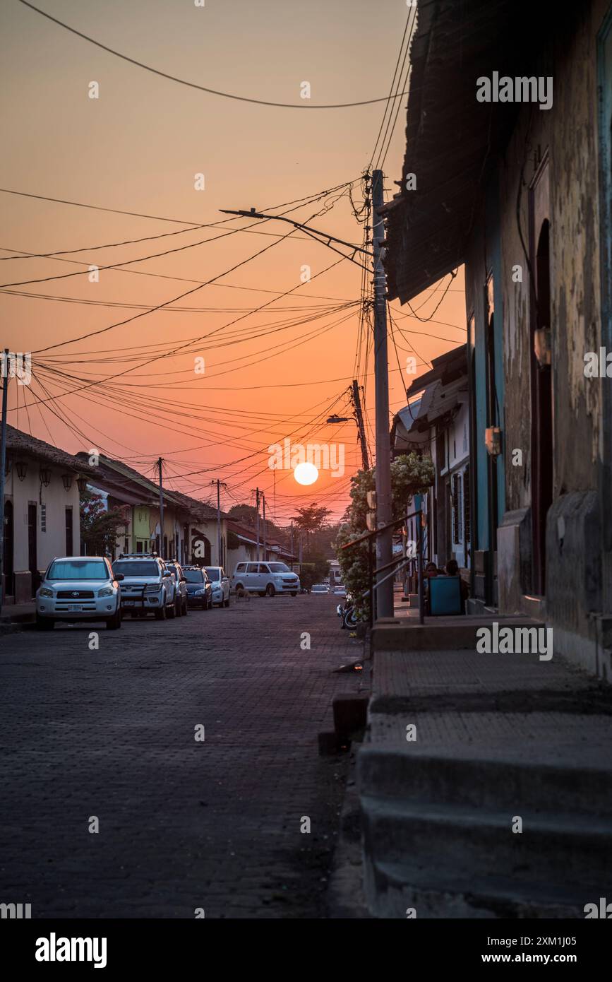 Sunset in a Street with typical residential houses in the Colonial-era city centre, Leon, Nicaragua Stock Photo