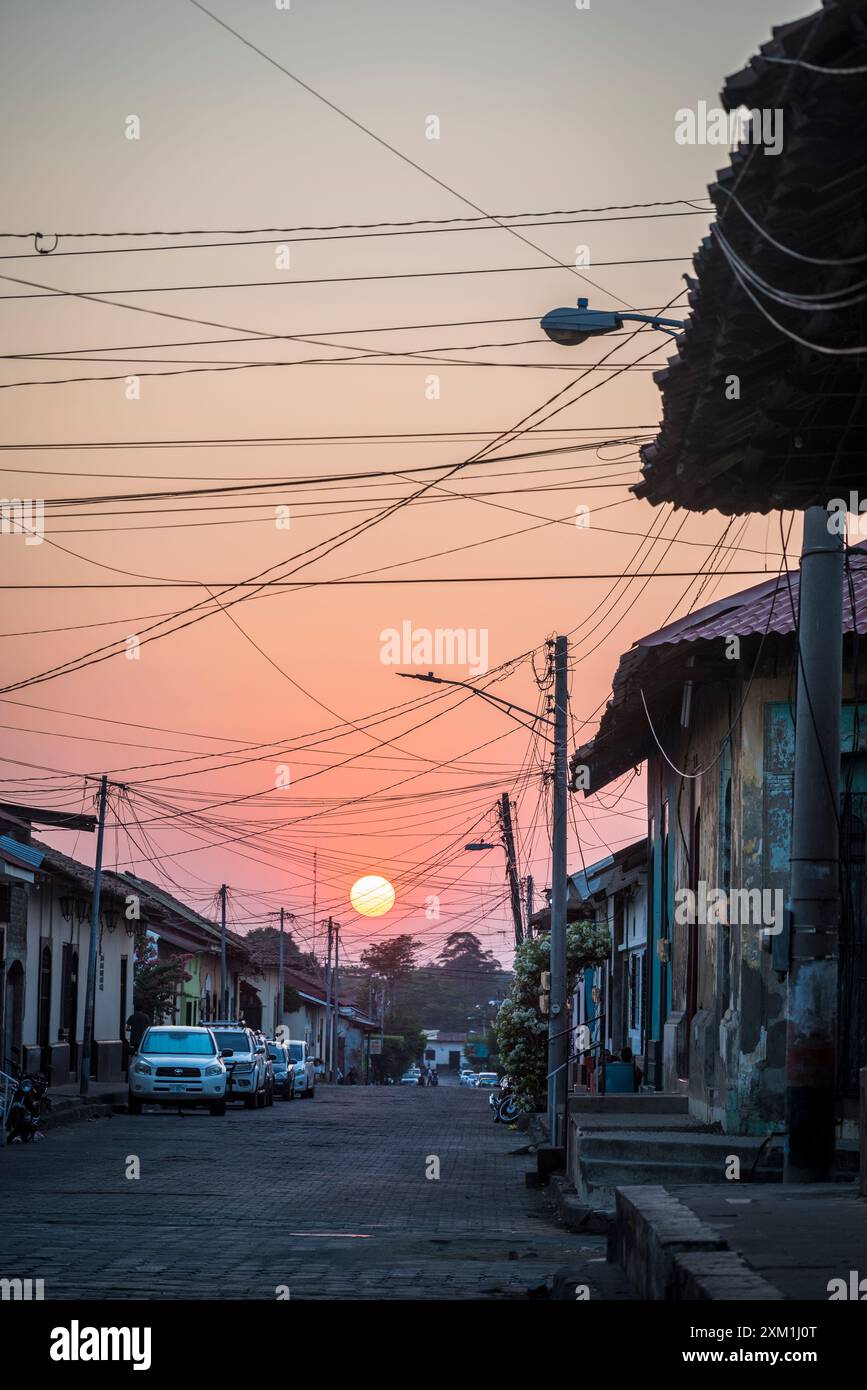 Sunset in a Street with typical residential houses in the Colonial-era city centre, Leon, Nicaragua Stock Photo