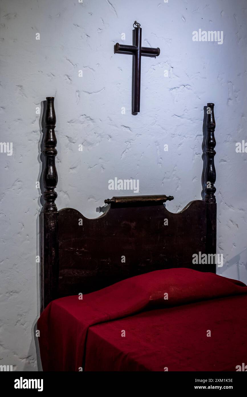 Cross above bed, Room dedicated to the colonial history of the country, National Museum of Costa Rica, San Jose, Costa Rica, Central America Stock Photo