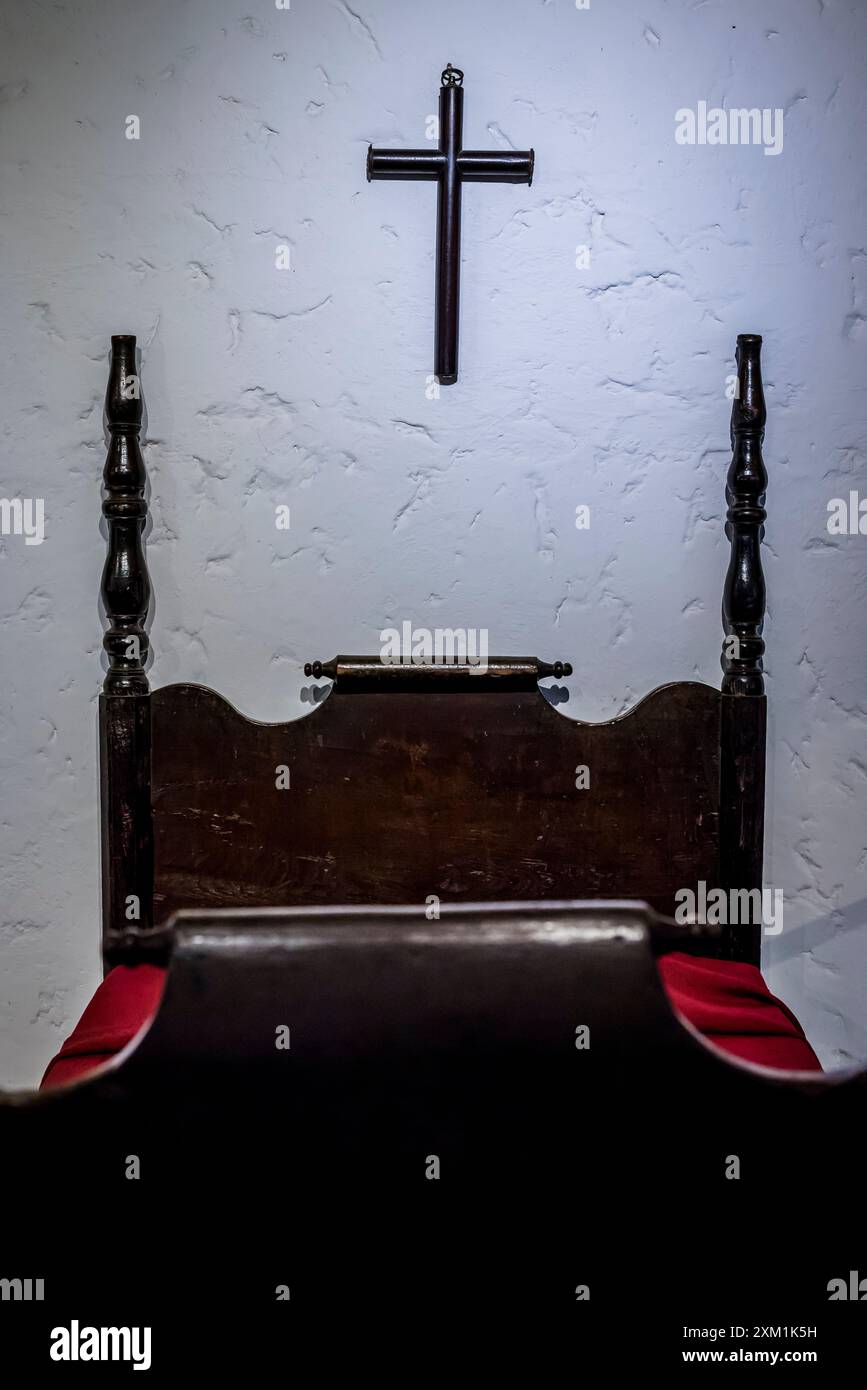 Cross above bed, Room dedicated to the colonial history of the country, National Museum of Costa Rica, San Jose, Costa Rica, Central America Stock Photo