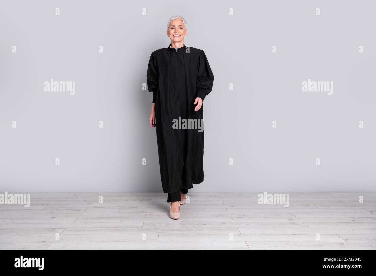 Judge Walking In Photo of woman judge walking wear black robe isolated grey color ...