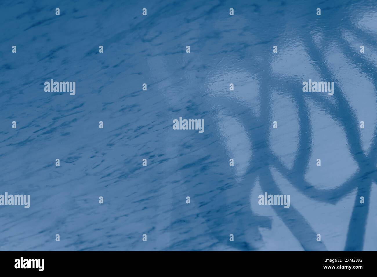 Light from the window on the blue marble floor inside the building. A Game of shadows from the falling rays of the sun on a stone surface Stock Photo