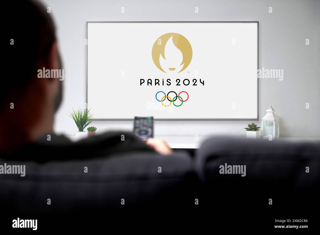 Paris, France July 24, 2024 Man watching Paris 2024 Olympic Games on