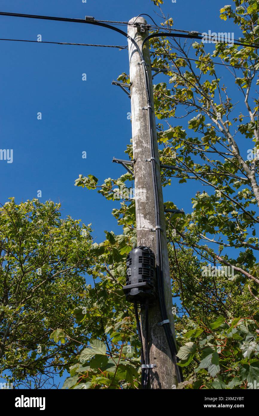 Overhead Fiber optic internet data cable sign on lampost Portfield gate, Pembrokeshire,Wales UK Stock Photo