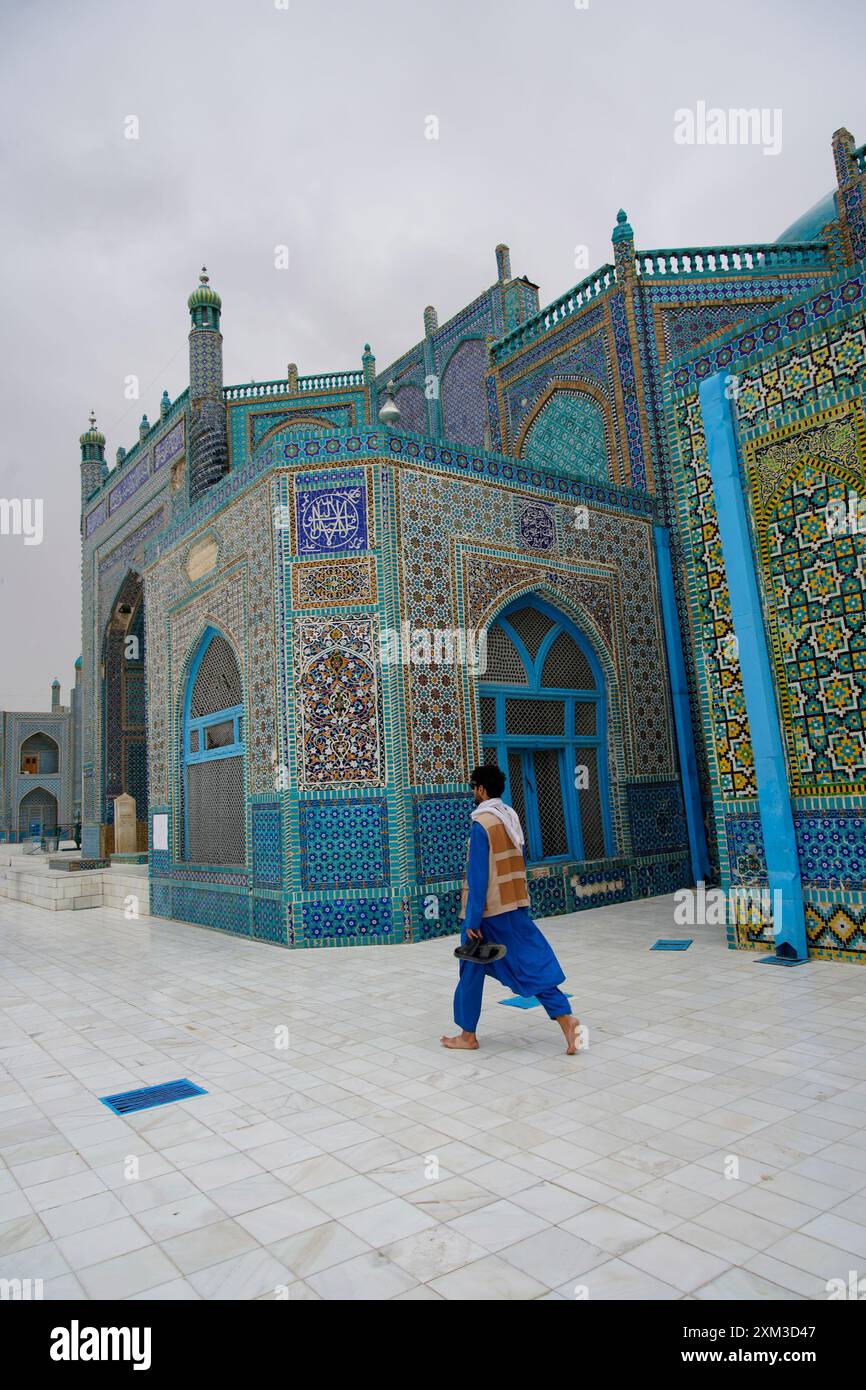 A man walks past the Shrine of Hazrat Ali, also known as The Blue ...