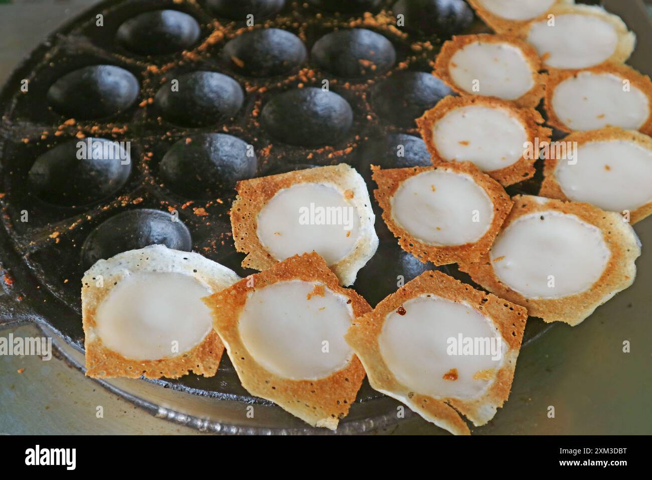 Freshly cooked Kanom Krok, Thai coconut milk bite-size pancakes which crispy edge and creamy inside Stock Photo