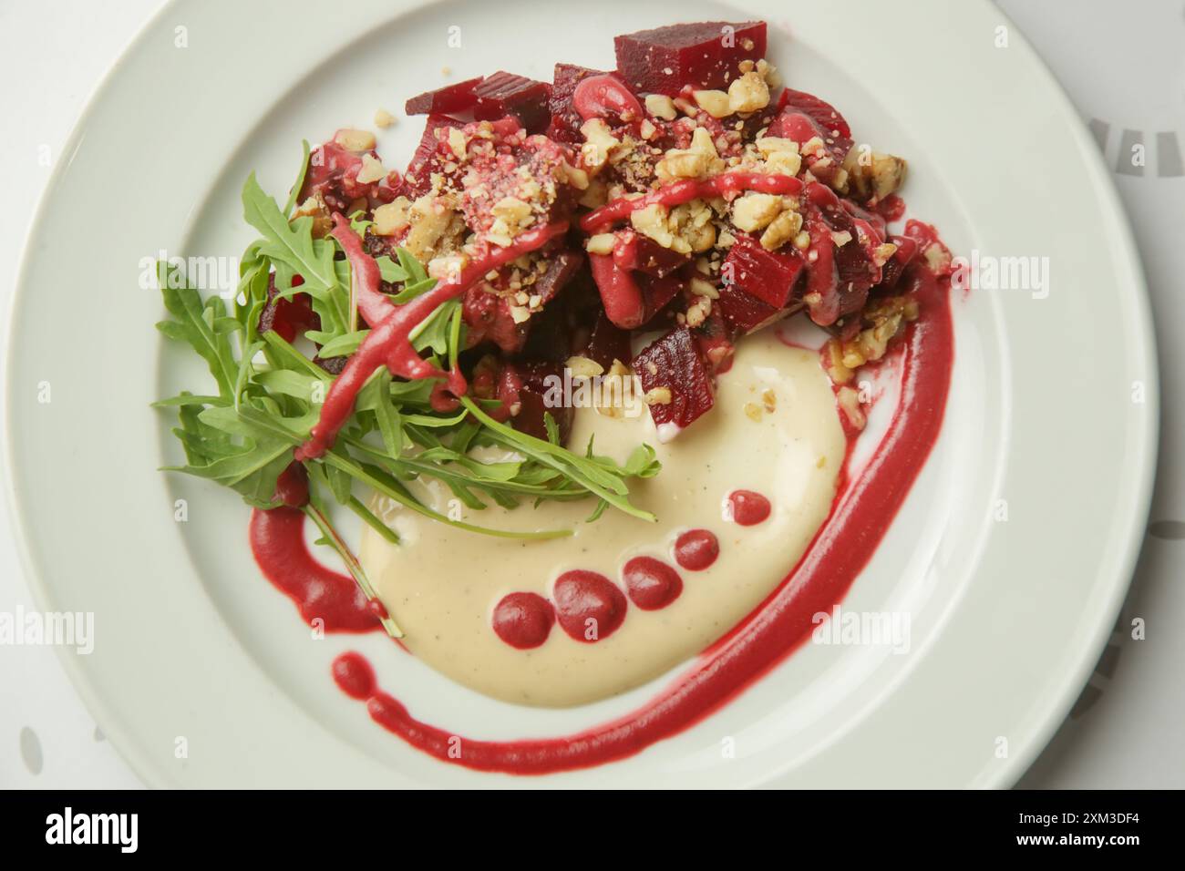 Beetroot salad served with hummus and fresh arugula Stock Photo