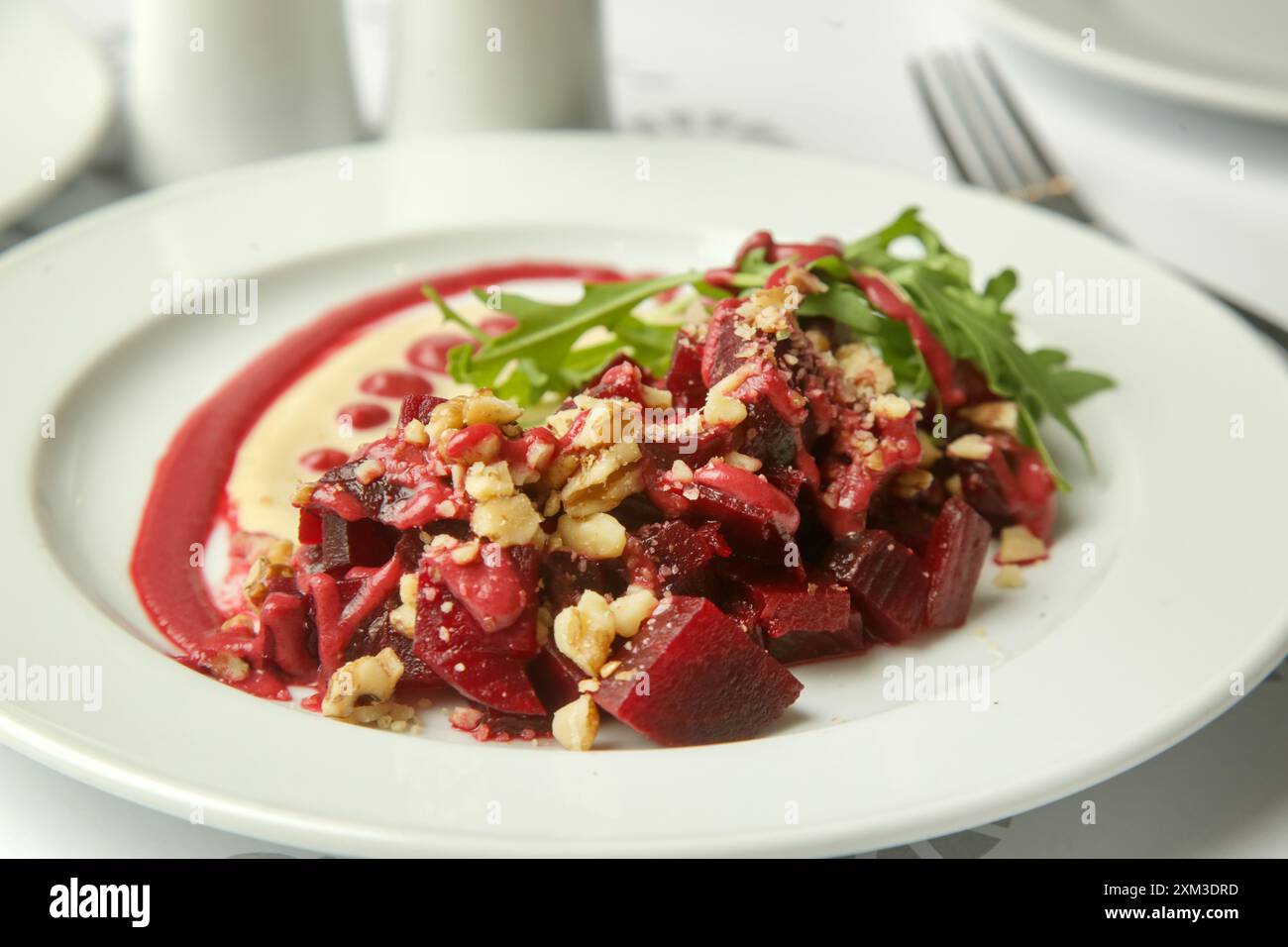 Beetroot salad served with hummus and fresh arugula Stock Photo