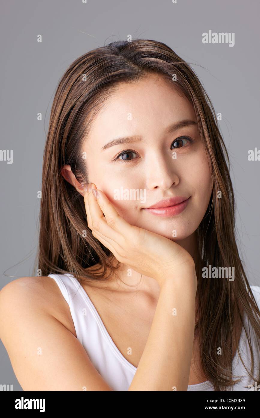 Beautiful Asian Woman With White Skin And Hand On Chin Stock Photo - Alamy