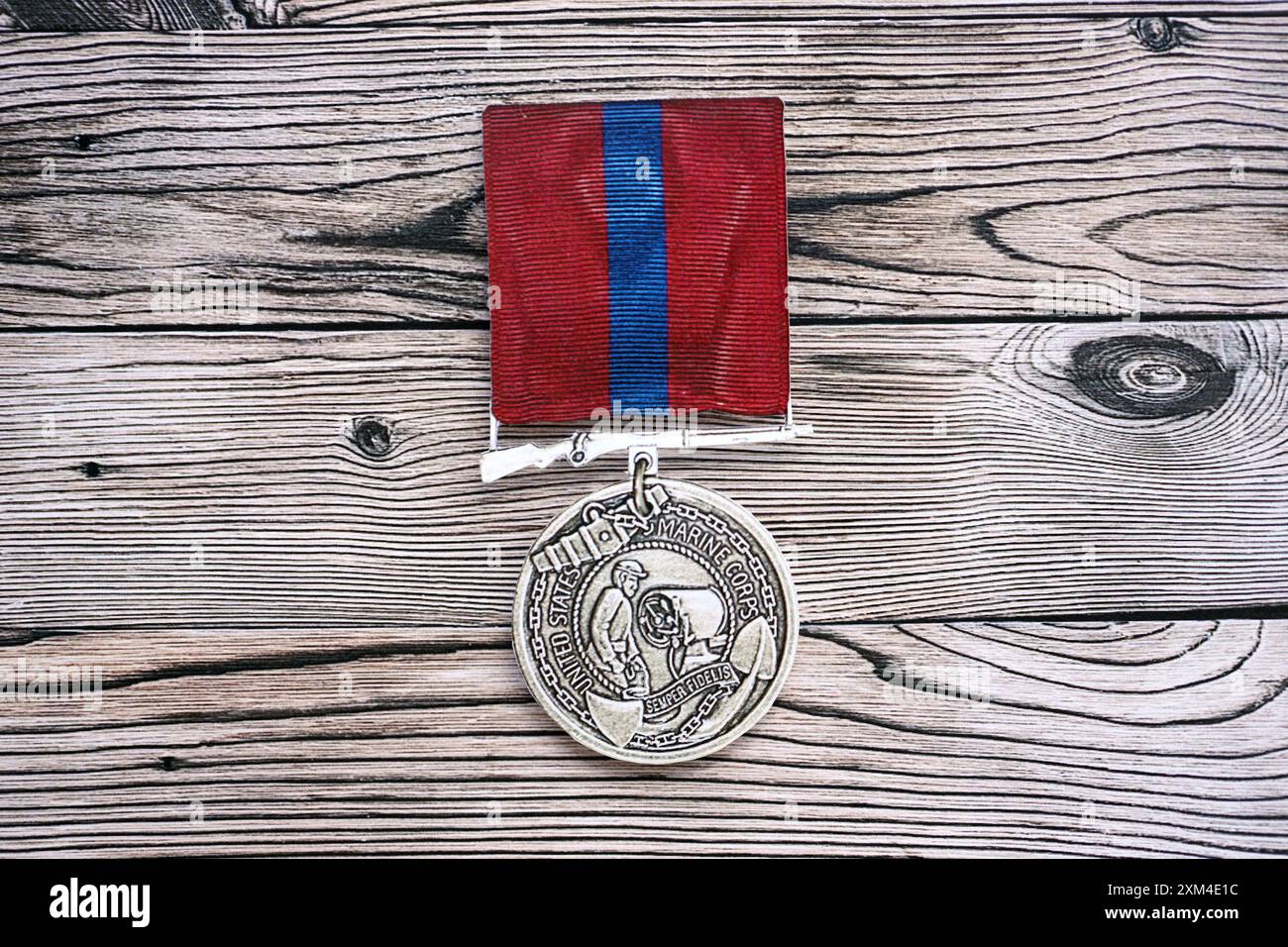 KYIV, UKRAINE - JULY 10, 2024 US Marine corps Army Good Conduct medal. United States military award medal with ribbon and pin. Handmade paper theater props close up Stock Photo