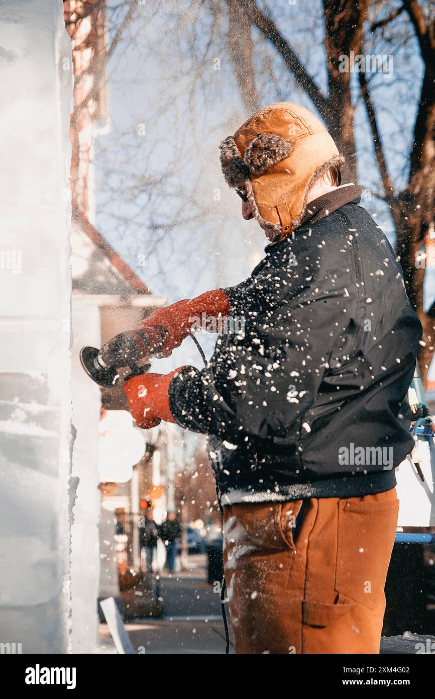 Lititz, Pennsylvania, USA: February 17, 2024A man in an ushanka hat makes ice sculptures Stock Photo