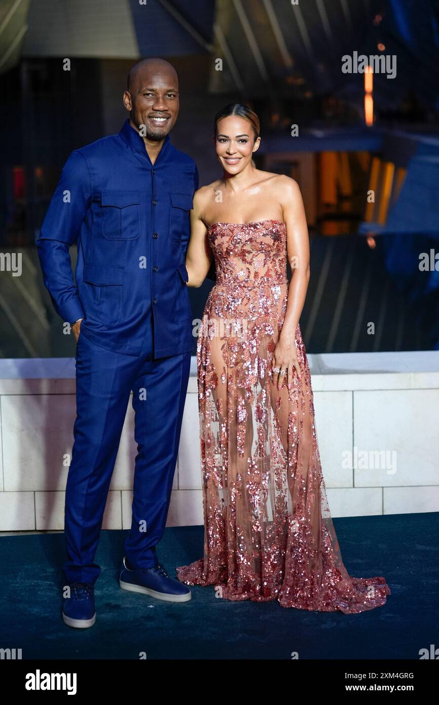 Didier Drogba left and Gabrielle Lemaire upon arrival at the Louis Vuitton Foundation on the eve of Paris Olympics opening ceremony at the 2024 Summer Olympics Thursday July 25 2024 in Paris