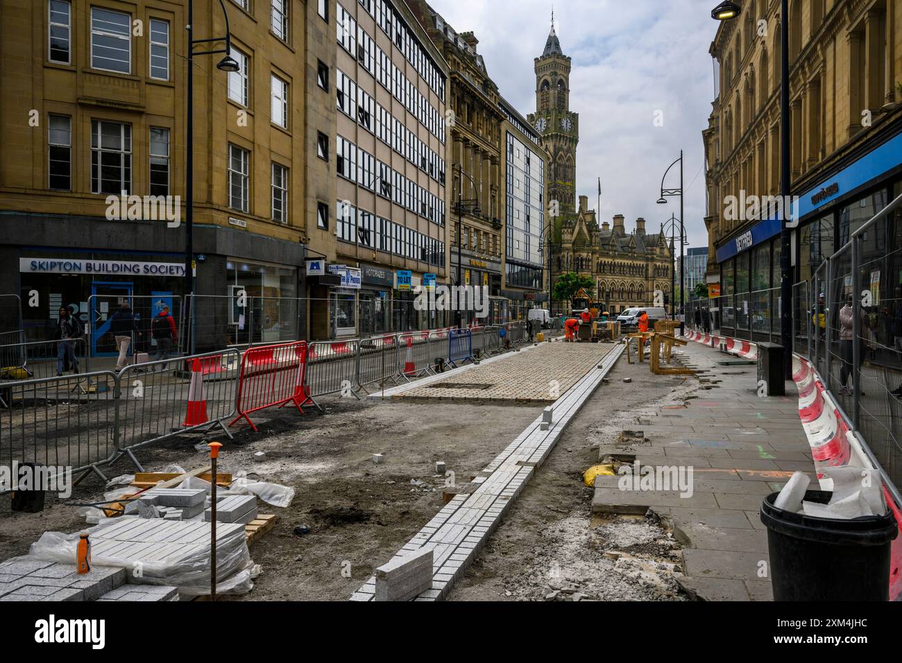 Walking Cycling Improvements creating pedestrianised zone (men working, roadworks, pavement closed) - transforming Bradford, West Yorkshire England UK Stock Photo