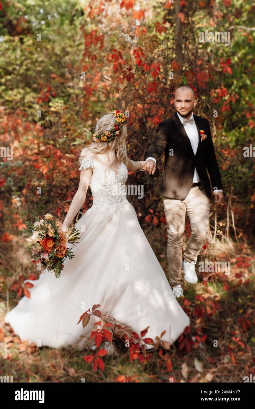 walk of the bride and groom through the autumn forest in October Stock ...