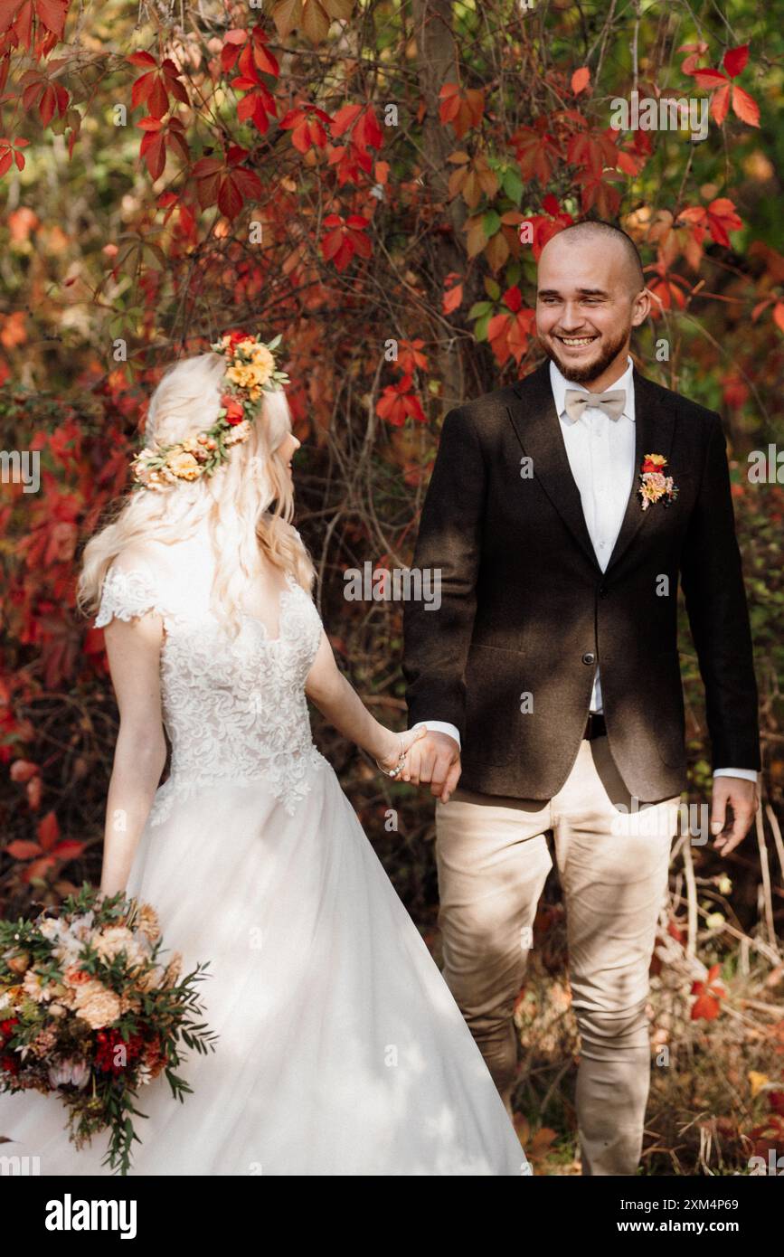 walk of the bride and groom through the autumn forest in October Stock ...