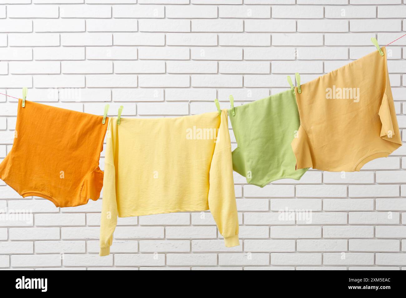 Clothes hanging clothesline wall casual clothing hi-res stock ...