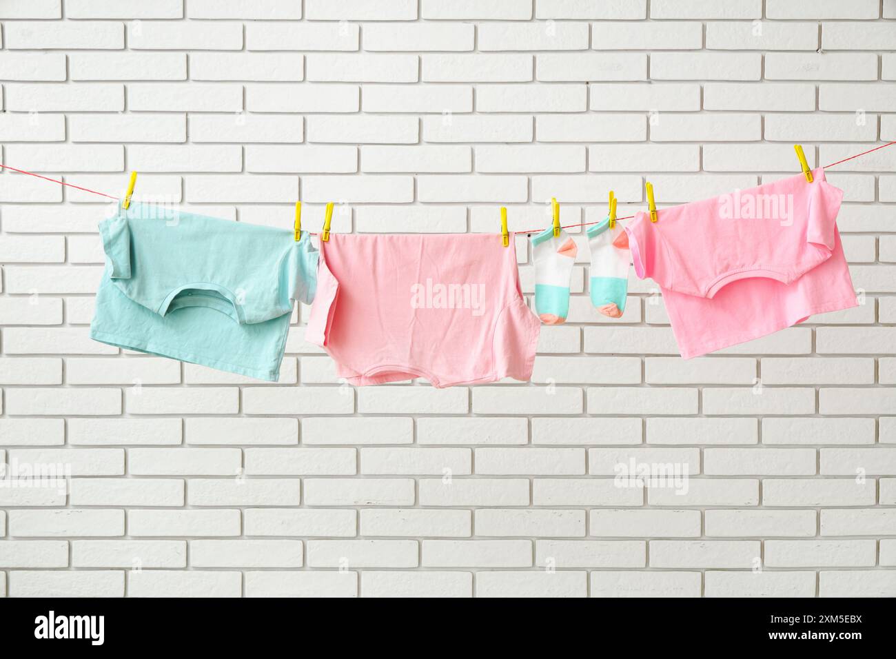 Clothes hanging clothesline wall casual clothing hi-res stock ...