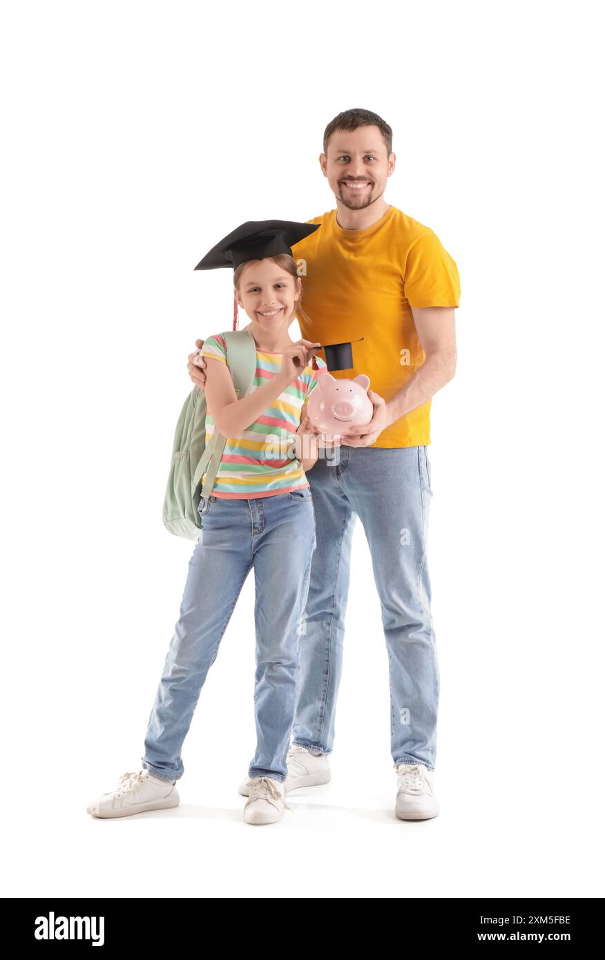 Father and his daughter with piggy bank in mortar board on white ...