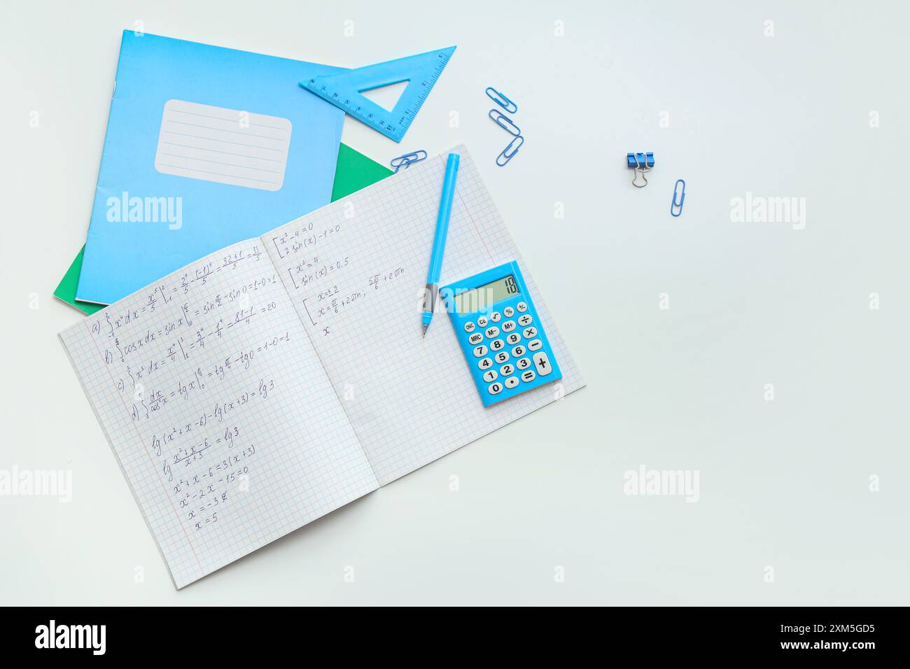 Blue Math Copy Book Open copybook with math formulas and stationery on light background ...