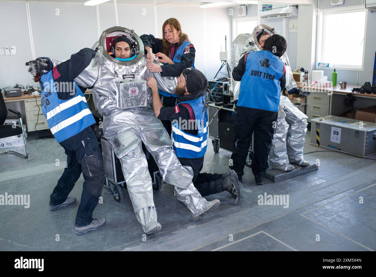 Analog astronaut Kartik Kumar, MSC, being assisted by support team during space suit preparation for the AMADEE-18 Mars mission simulation in Oman Stock Photo