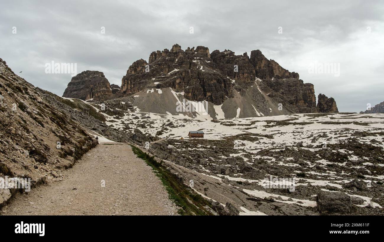 Dolomites’ snowy allure Hiking Tre Cime Circuit in June with foggy peaks and dramatic weather