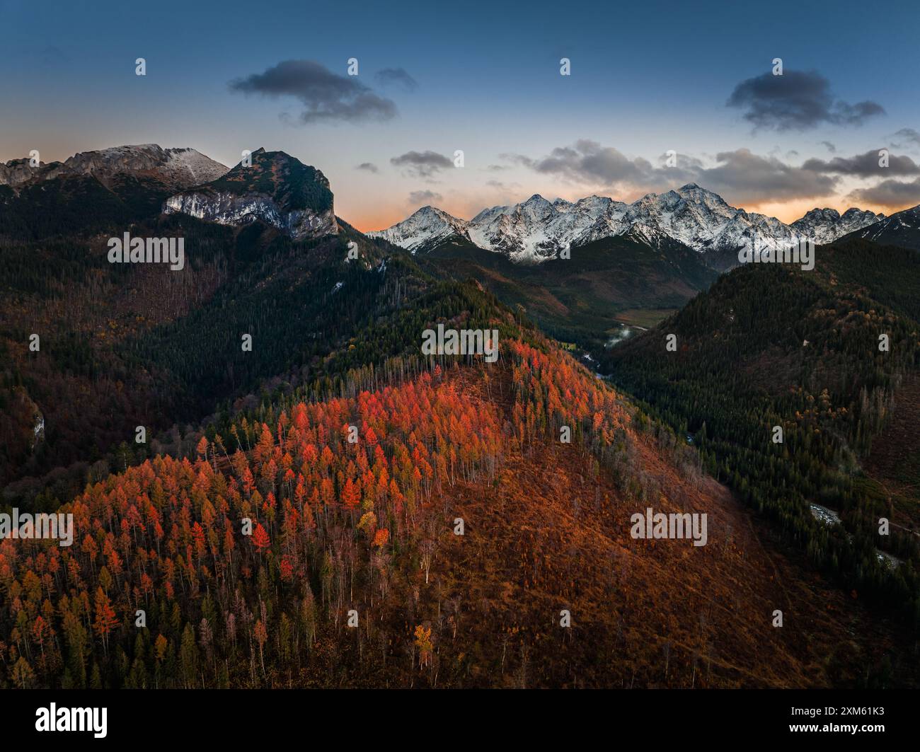 High Tatras, Slovakia - Aerial view of the snowy mountains of the High Tatras with beautiful with autumn foliage and clear blue sky at Vysoke Tatry Stock Photo