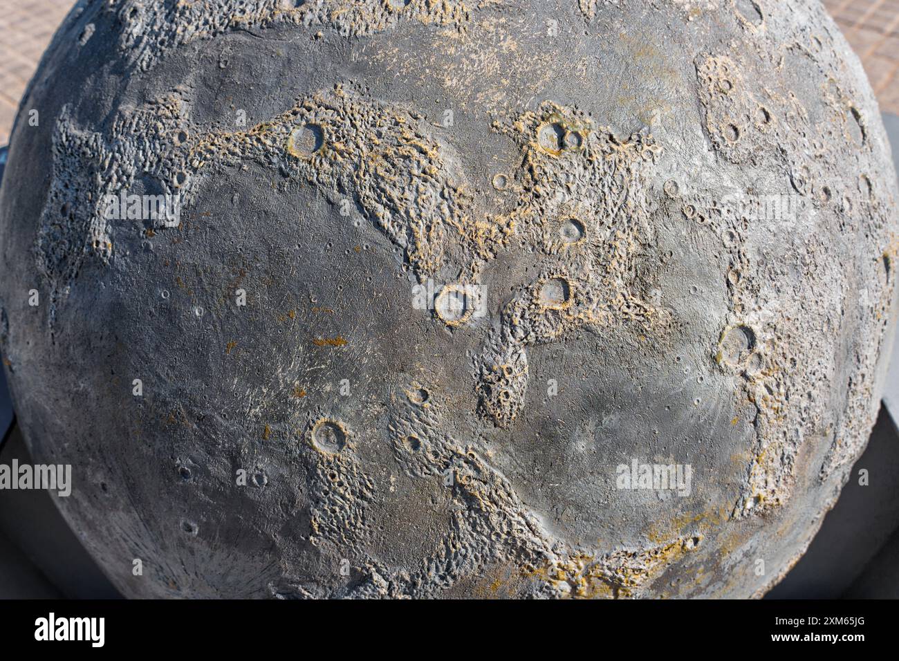 Detailed view of lunar-like surface texture showcasing craters, cracks, and rugged features. Ideal for astronomy enthusiasts and artistic projects. Stock Photo