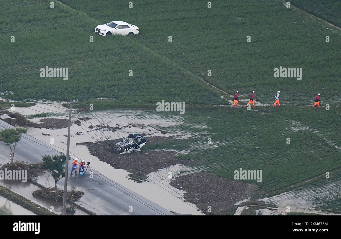An aerial photo shows the site where a police car and cars were swept ...