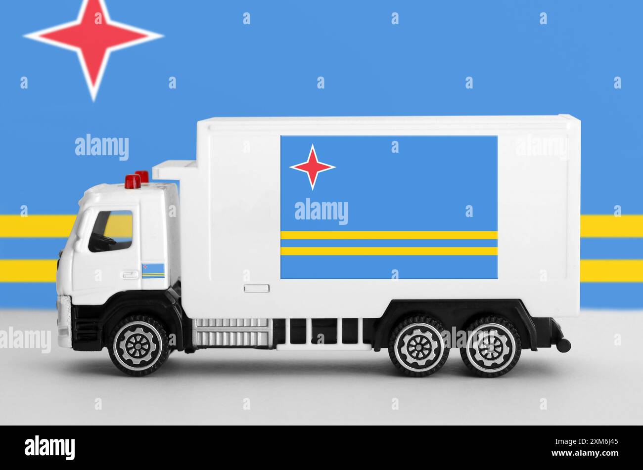 Aruba flag depicted on side wall of white delivery van close up. Shipping and local delivery concept Stock Photo