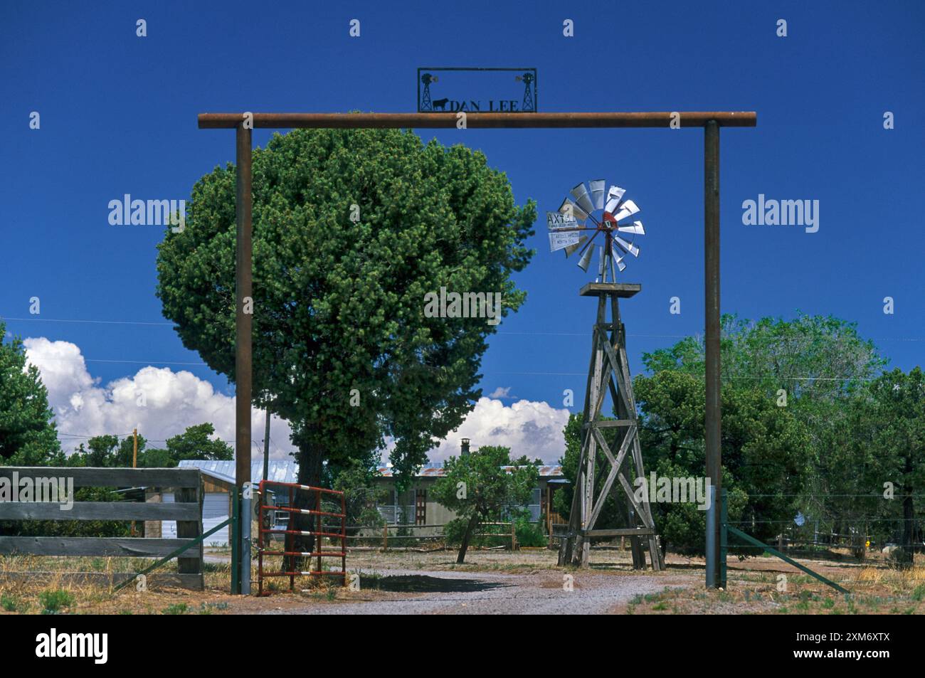 Wrought iron ranch gate and windmill in Pie Town in Catron County, New Mexico, USA Stock Photo