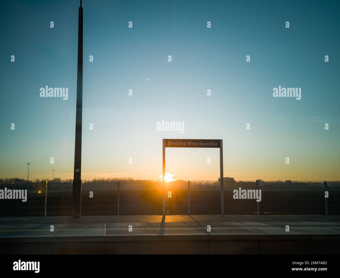 Bielany Wroclawskie, Poland - January 29 2024: Beautiful morning sunrise with shining sun going up from behind the horizon seen from train window at B Stock Photo