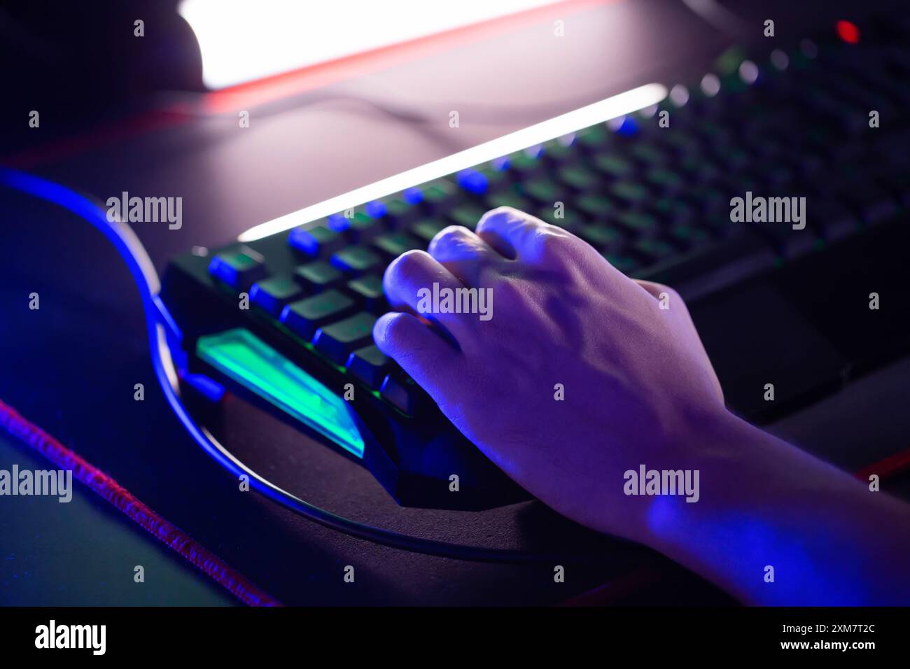 Left-handed gamer plays video game on PC computer club, cyber sport tournament. Skill. Professional E-sport championship. Fingers press keys on gaming Stock Photo