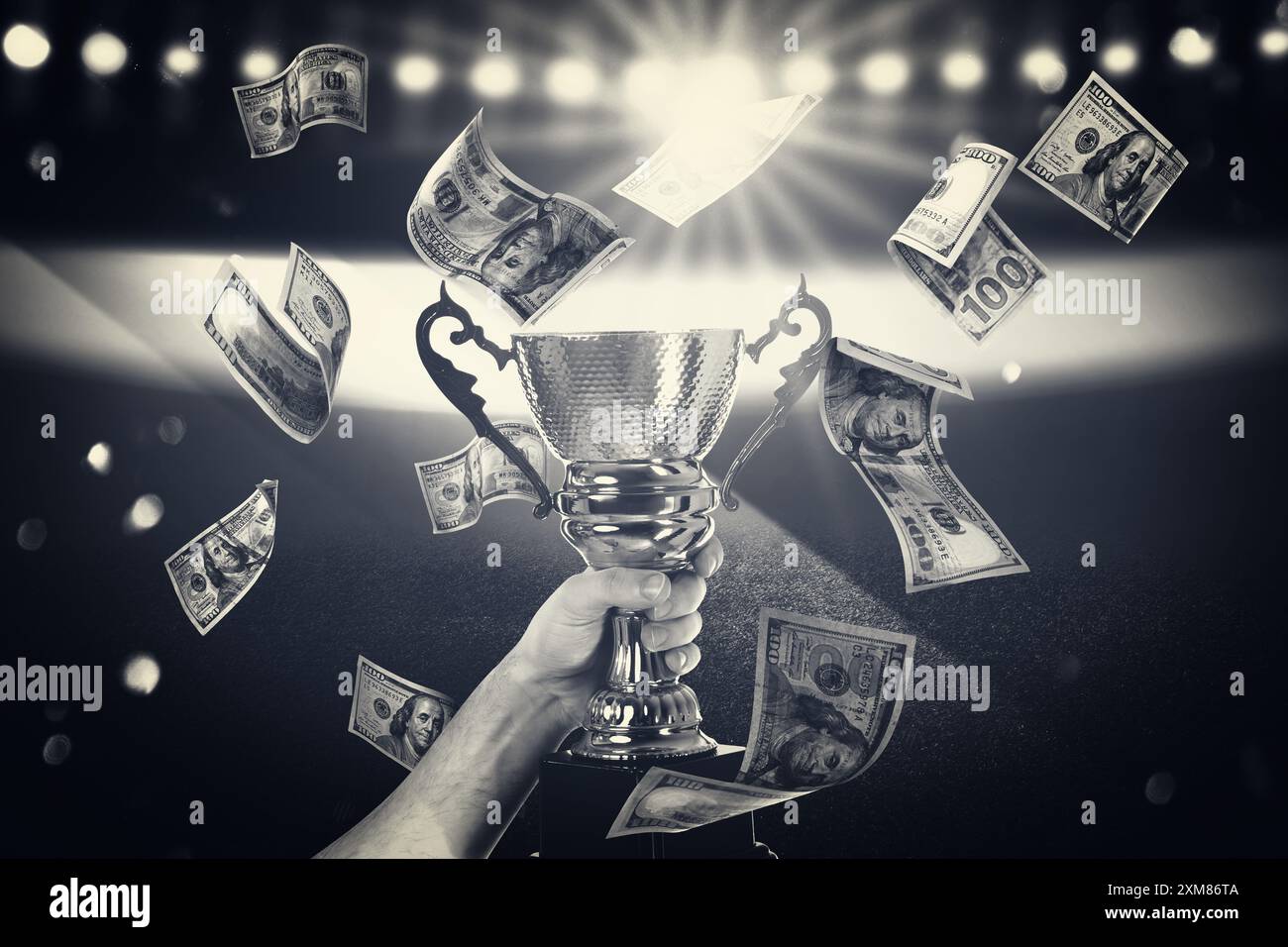 Man holding trophy cup in money rain at stadium, closeup. Color toned Stock Photo