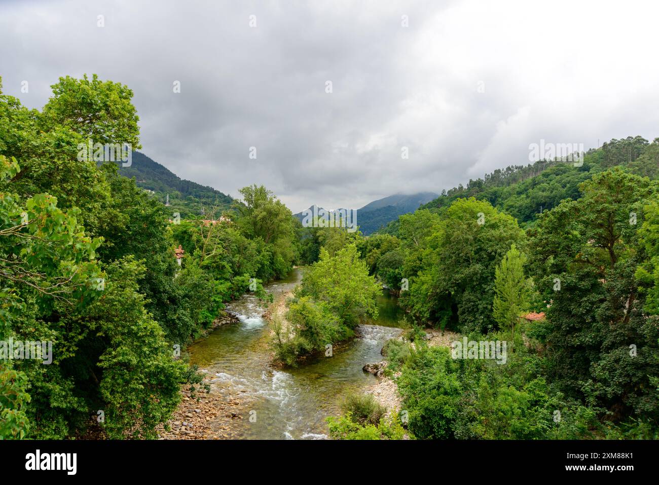 View of river in the mountains agains cloudy sky Stock Photo - Alamy
