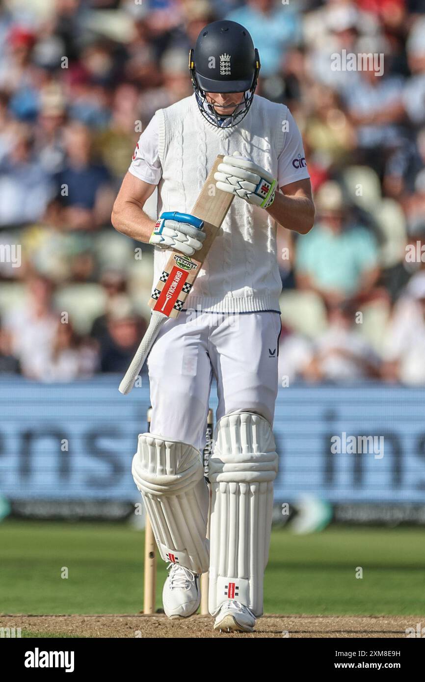 A dejected Zak Crawley of England looks at his bat after he is caught out by Jason Holder of West Indies during the 3rd Rothesay Test Match Day One match England vs West Indies at Edgbaston, Birmingham, United Kingdom, 26th July 2024  (Photo by Mark Cosgrove/News Images) Stock Photo