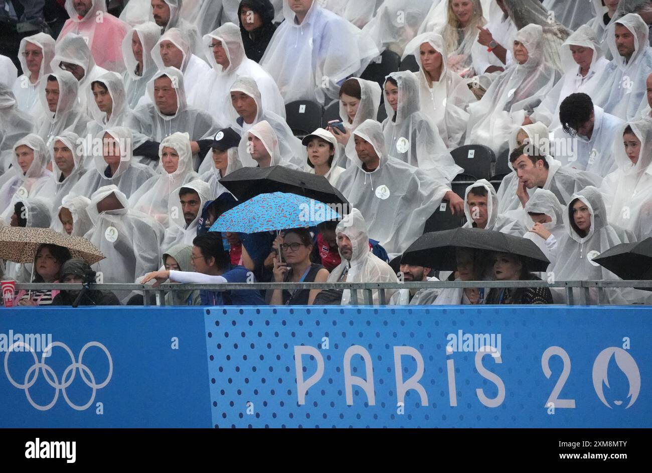 Paris, France. 26th July, 2024. Spectators with rain ponchos and umbrellas wait for the start of the Opening Ceremony of the Paris 2024 Olympic Games in Paris, France, on Friday, July 26, 2024. Over 10,000 athletes from 206 countries will compete in the summer Olympic games, which take place from July 26 to August 11. Photo by Richard Ellis/UPI Credit: UPI/Alamy Live News Stock Photo