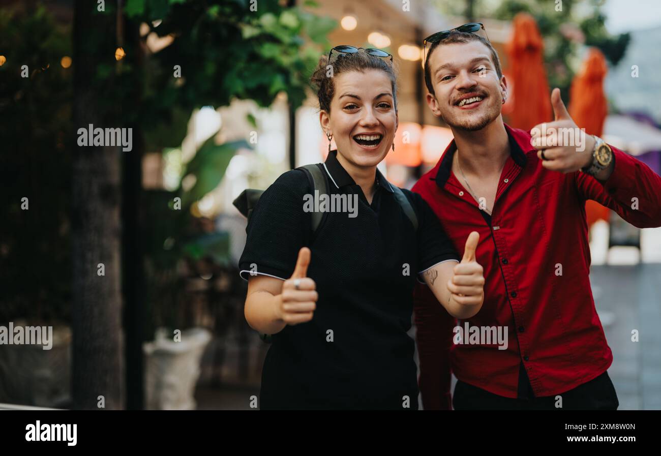 Happy friends giving thumbs up gesture while enjoying outdoor gathering ...
